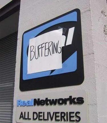 A Real Networks building sign, which somebody has covered with some paper with handwriting saying BUFFERING