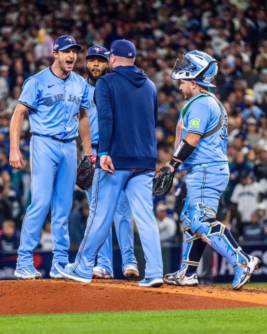 Game 4 ALCS pic of John Schneider's first mound visit to Max Scherzer. Max is staring down and yelling at Schneider, making his case to stay in and finish the 5th inning. Kirk and Guerrero Jr are also by the pitcher's mound